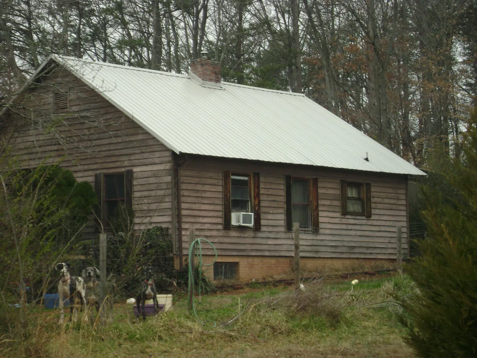 White metal roof on an old wood sided farmhouse, from a Metal Roof Installation job in Summer Shade